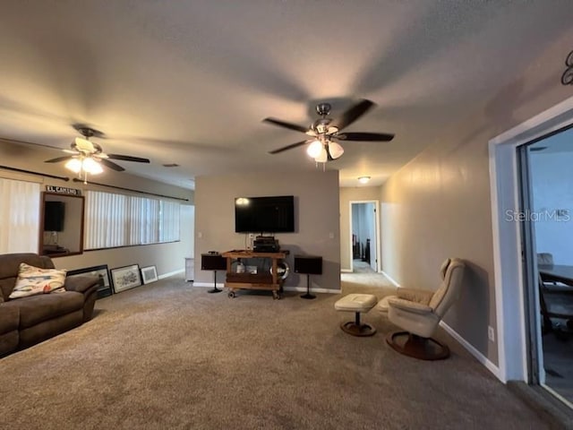 carpeted living room with ceiling fan