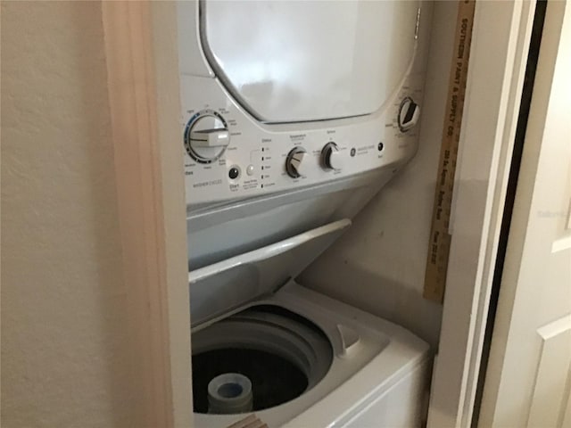 clothes washing area featuring laundry area and stacked washer and clothes dryer