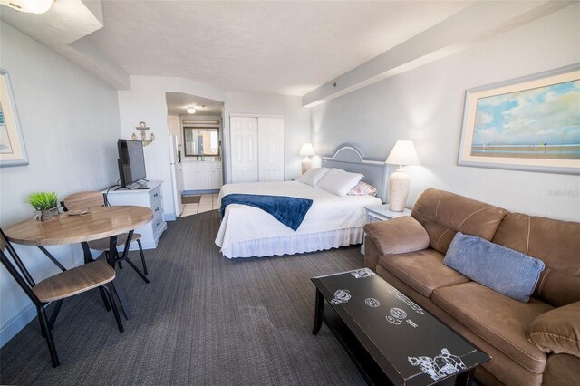 2700 N Atlantic Ave Unit 517, Daytona Beach, FL 32118 - carpeted bedroom with connected bathroom and a closet