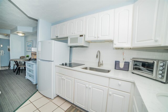 2700 N Atlantic Ave Unit 517, Daytona Beach, FL 32118 - kitchen featuring white appliances, light countertops, and white cabinetry