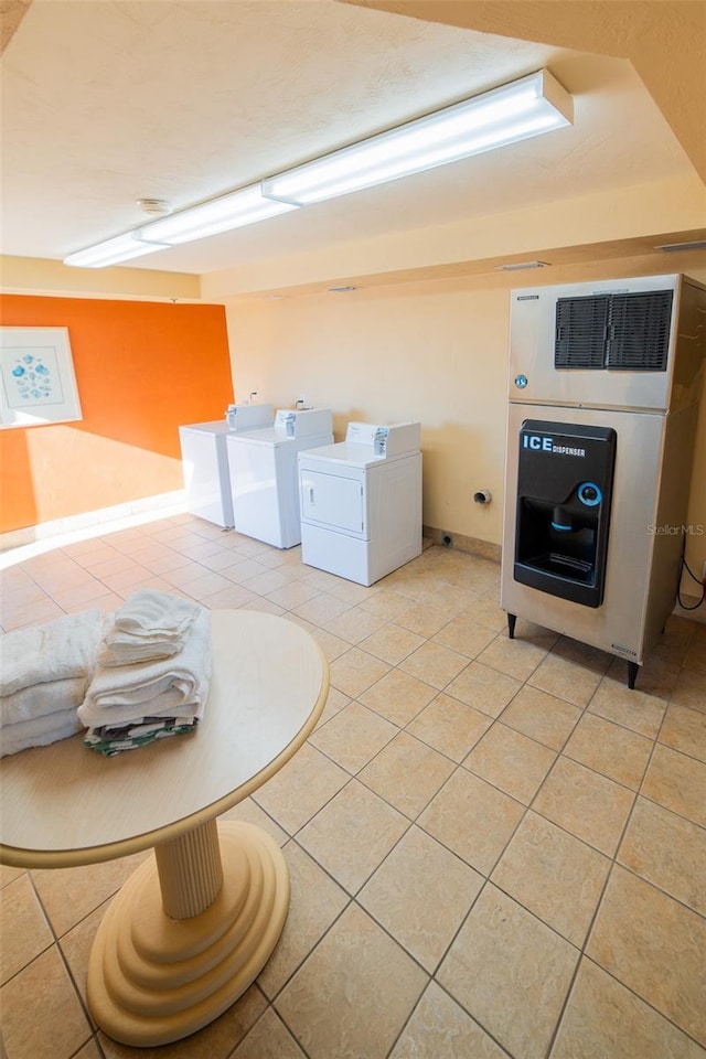 2700 N Atlantic Ave Unit 517, Daytona Beach, FL 32118 - shared laundry room with washing machine and clothes dryer and light tile patterned flooring