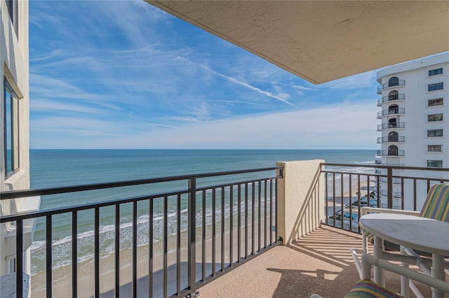 balcony with a view of the beach and a water view