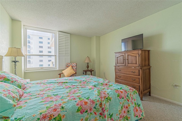 carpeted bedroom featuring a textured ceiling