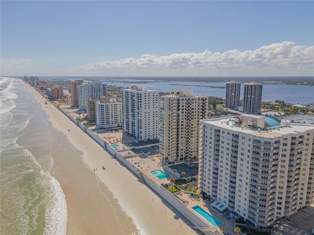 bird's eye view with a water view and a beach view