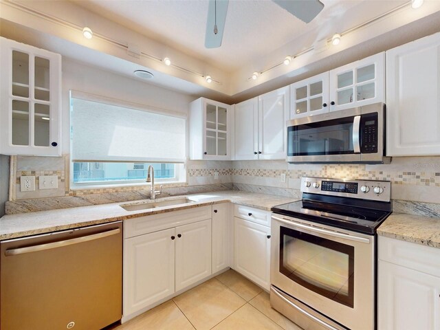5300 S Atlantic Ave Unit 9201, New Smyrna Beach, FL 32169 - kitchen featuring appliances with stainless steel finishes, white cabinetry, and backsplash