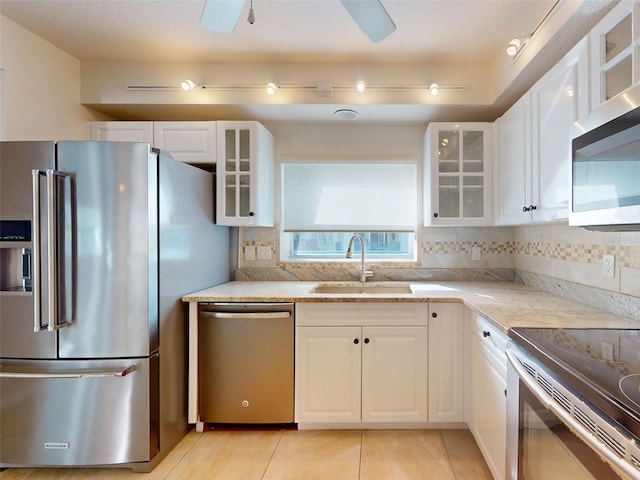 5300 S Atlantic Ave Unit 9201, New Smyrna Beach, FL 32169 - kitchen featuring ceiling fan, sink, appliances with stainless steel finishes, backsplash, and white cabinetry