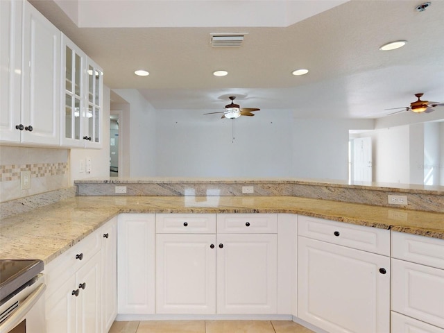 5300 S Atlantic Ave Unit 9201, New Smyrna Beach, FL 32169 - kitchen featuring range, white cabinetry, light stone counters, and ceiling fan