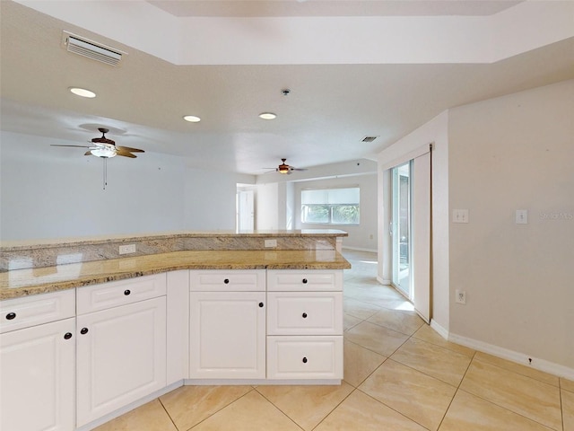5300 S Atlantic Ave Unit 9201, New Smyrna Beach, FL 32169 - kitchen featuring ceiling fan, white cabinets, light tile floors, and light stone counters