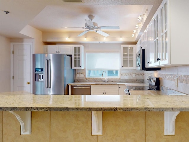 5300 S Atlantic Ave Unit 9201, New Smyrna Beach, FL 32169 - kitchen with light stone countertops, kitchen peninsula, sink, stainless steel appliances, and white cabinets