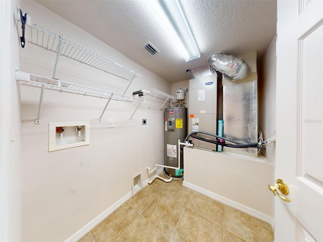 5300 S Atlantic Ave Unit 9201, New Smyrna Beach, FL 32169 - laundry area featuring hookup for an electric dryer, light tile floors, hookup for a washing machine, electric water heater, and a textured ceiling
