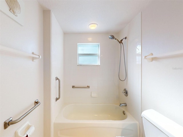 5300 S Atlantic Ave Unit 9201, New Smyrna Beach, FL 32169 - bathroom with toilet, a textured ceiling, and tiled shower / bath