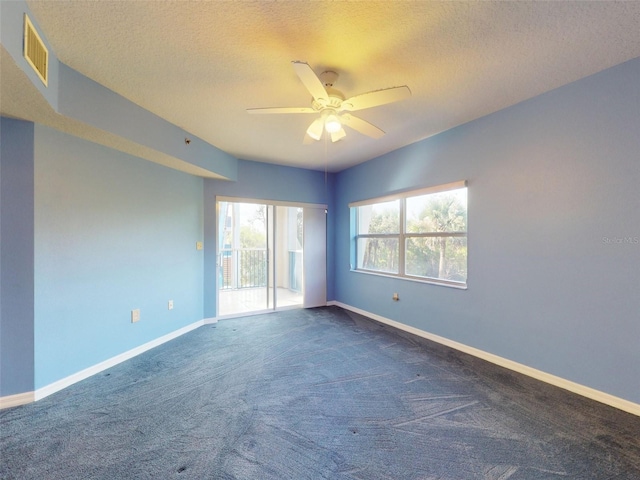 5300 S Atlantic Ave Unit 9201, New Smyrna Beach, FL 32169 - spare room with dark colored carpet, ceiling fan, and a textured ceiling