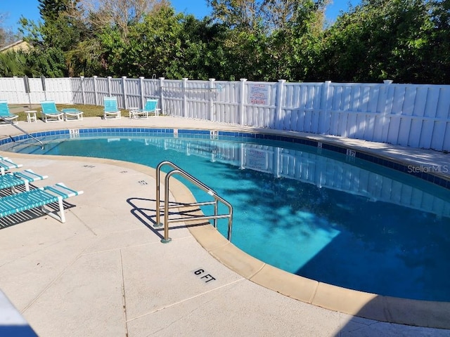 view of swimming pool featuring a patio area