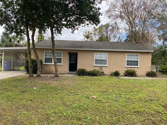 ranch-style home with a carport and a front lawn