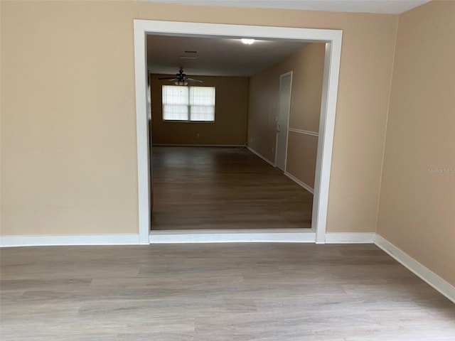 hallway with light hardwood / wood-style floors