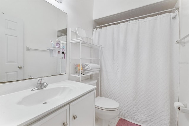 bathroom with vanity, tile patterned flooring, and toilet