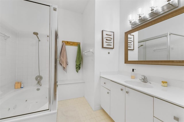 bathroom featuring tiled shower / bath combo, vanity, and tile patterned floors