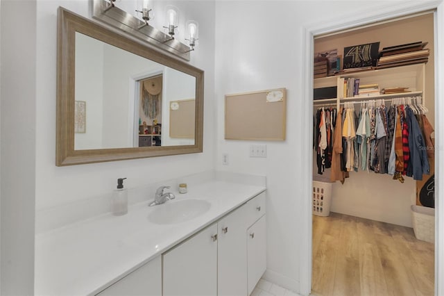 bathroom with hardwood / wood-style flooring and vanity