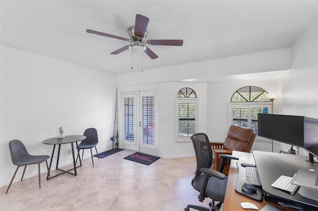 office space featuring french doors, ceiling fan, and a textured ceiling