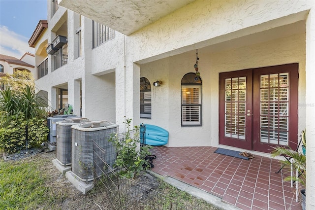 entrance to property featuring french doors and central AC unit