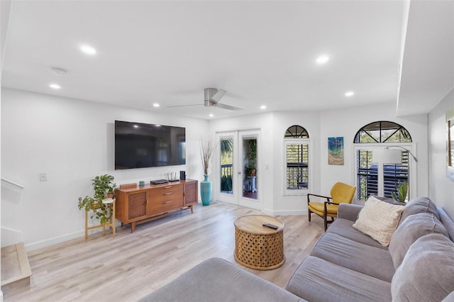 living room featuring ceiling fan, light wood-type flooring, and french doors