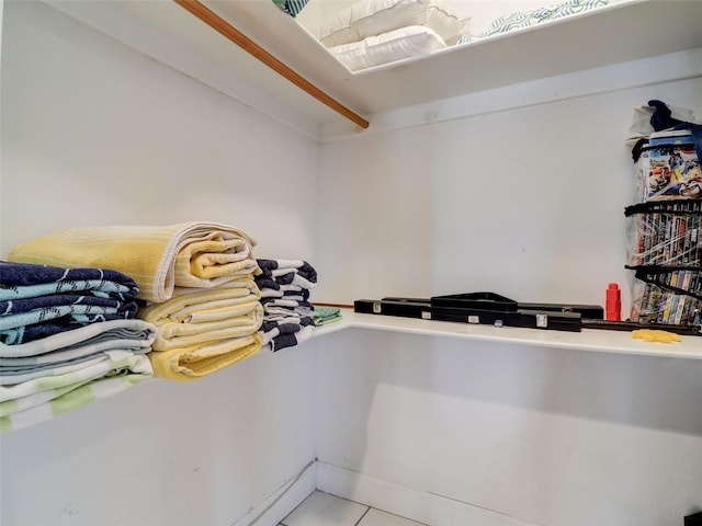walk in closet featuring light tile flooring