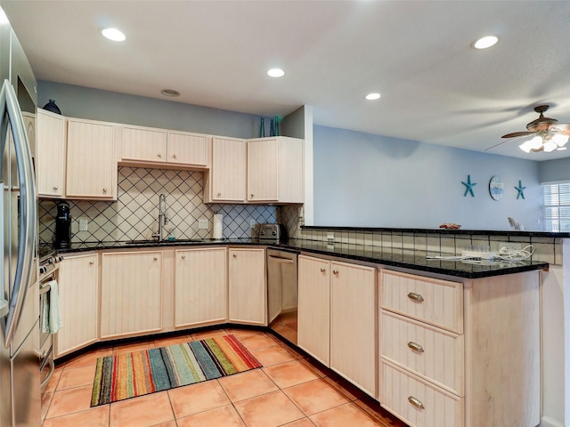 kitchen with kitchen peninsula, backsplash, ceiling fan, sink, and light tile floors