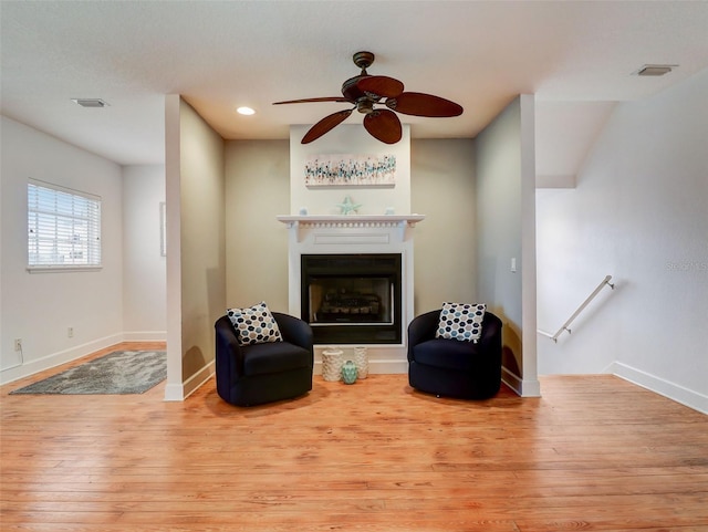 living area featuring ceiling fan and light wood-type flooring