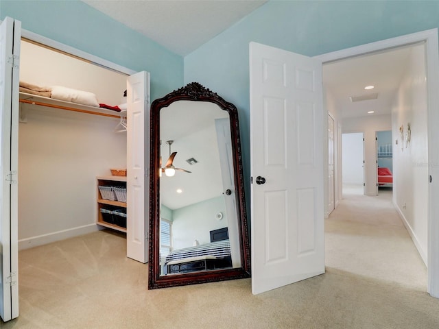 interior space featuring light carpet and a closet