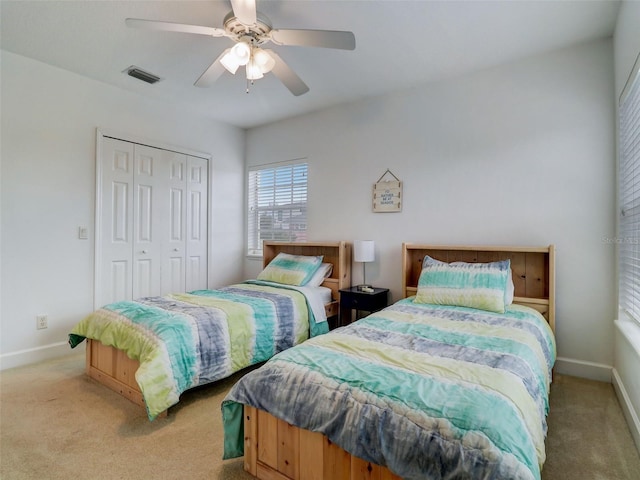bedroom with light carpet, a closet, and ceiling fan
