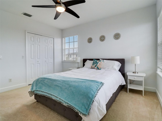 bedroom featuring a closet, ceiling fan, and light colored carpet
