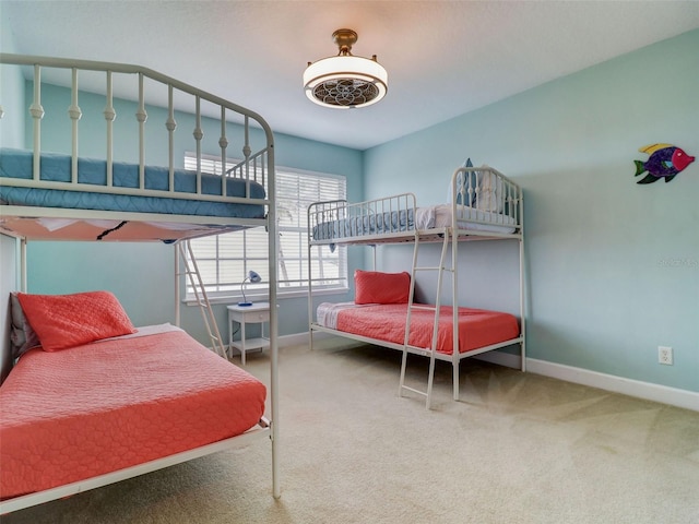 bedroom featuring light carpet and ceiling fan