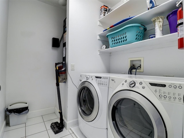 clothes washing area with hookup for a washing machine, separate washer and dryer, and light tile floors