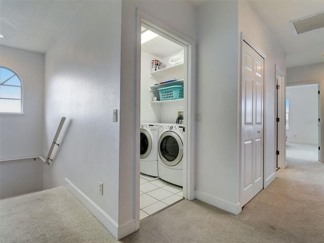 clothes washing area featuring washing machine and dryer, light carpet, and washer hookup