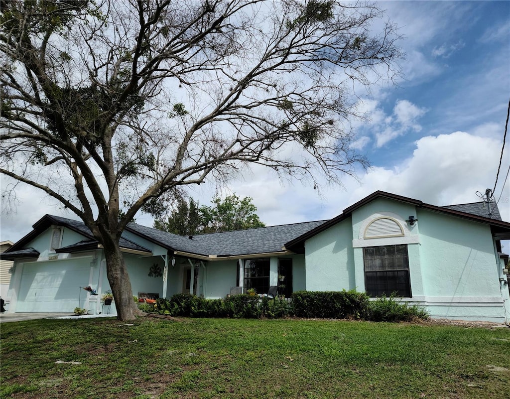 1470 NE Old Mill Dr, Deltona, FL 32725 - single story home featuring stucco siding, a front yard, and a garage