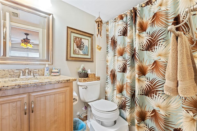 bathroom featuring toilet and vanity