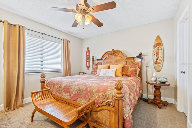 carpeted bedroom with ceiling fan and a textured ceiling