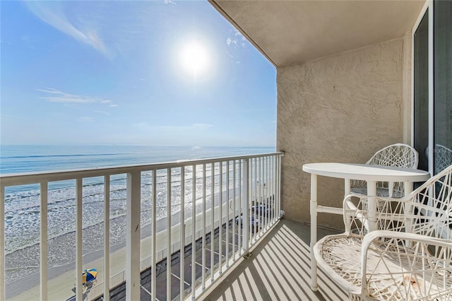 balcony with a view of the beach and a water view