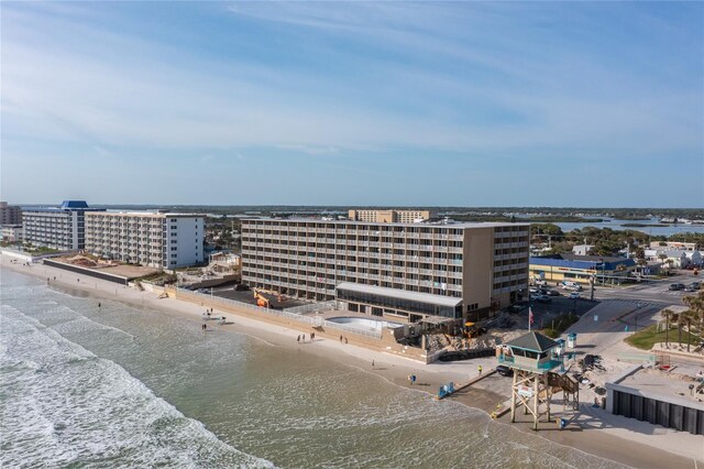 drone / aerial view with a water view and a beach view