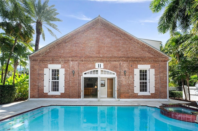 view of swimming pool with an in ground hot tub and a patio area