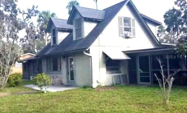 rear view of property with a yard