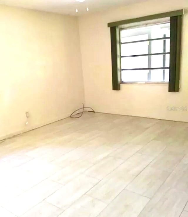 unfurnished room featuring light wood-type flooring