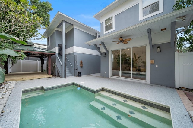 view of pool featuring a gazebo, ceiling fan, and a patio area