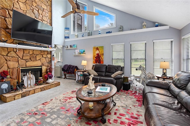 living room with ceiling fan, carpet floors, a fireplace, and high vaulted ceiling