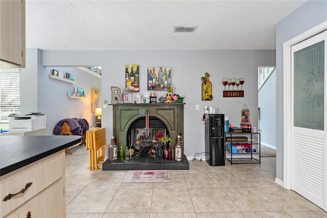 tiled living room with a textured ceiling