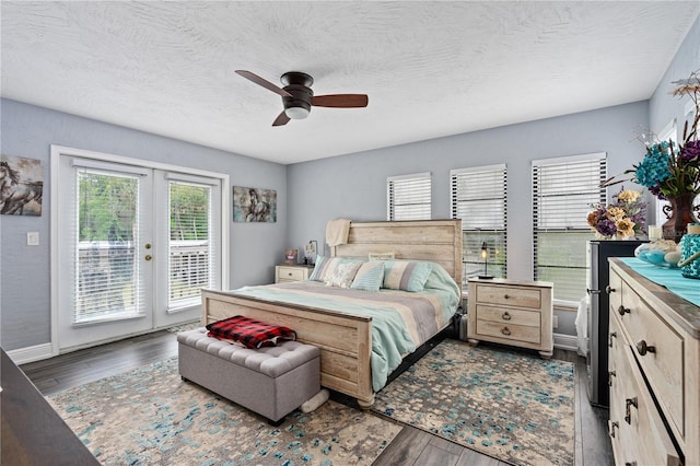 bedroom featuring access to outside, french doors, ceiling fan, a textured ceiling, and dark hardwood / wood-style flooring