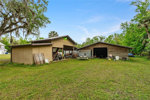 back of property featuring a lawn and an outdoor structure