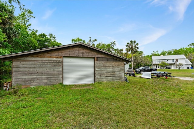 garage featuring a lawn