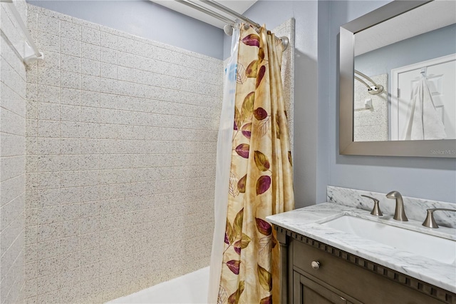 bathroom with shower / tub combo with curtain and vanity