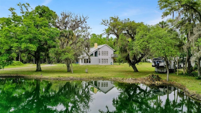 view of community featuring a yard and a water view